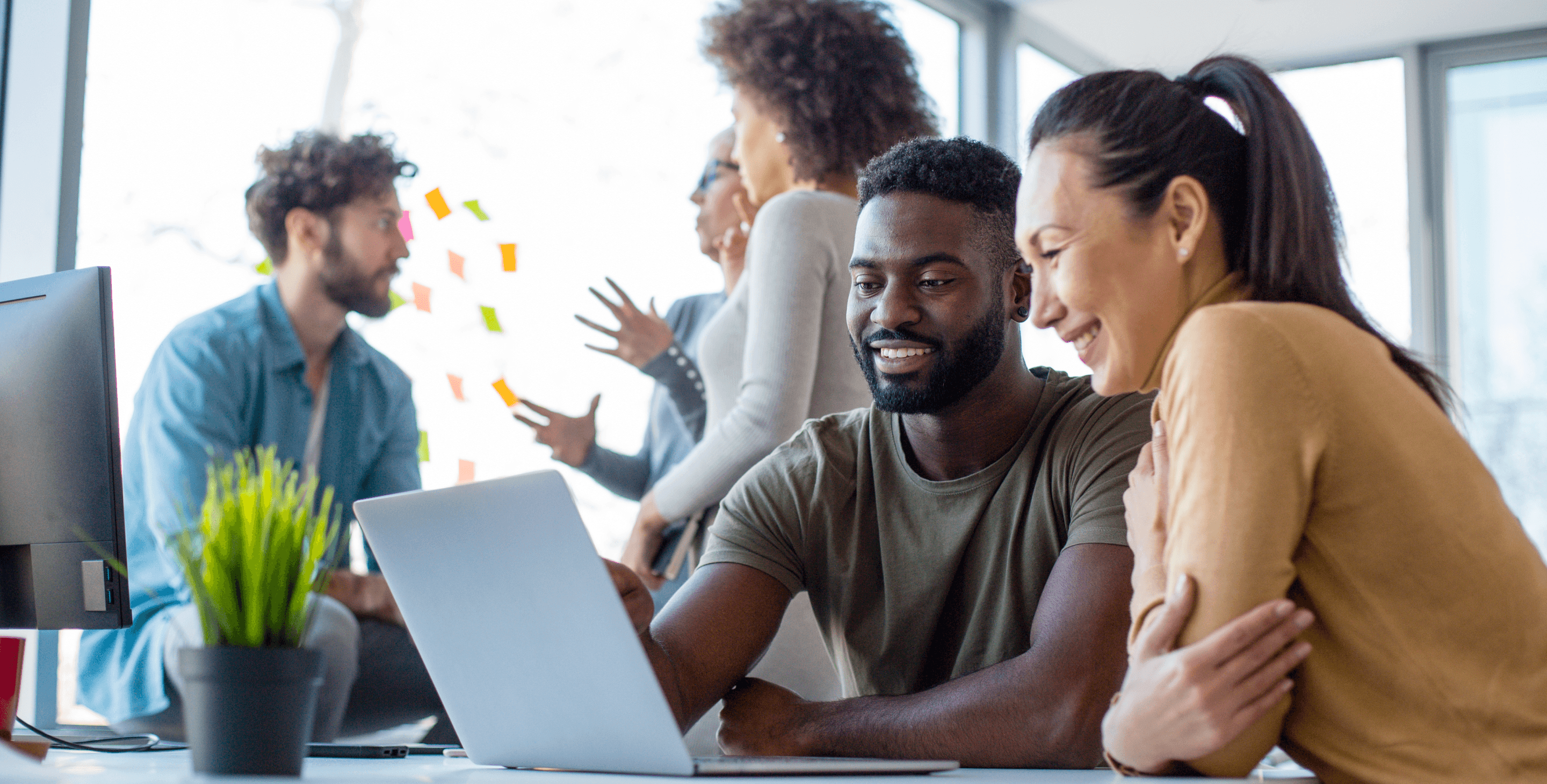 Two Persons working on a laptop
