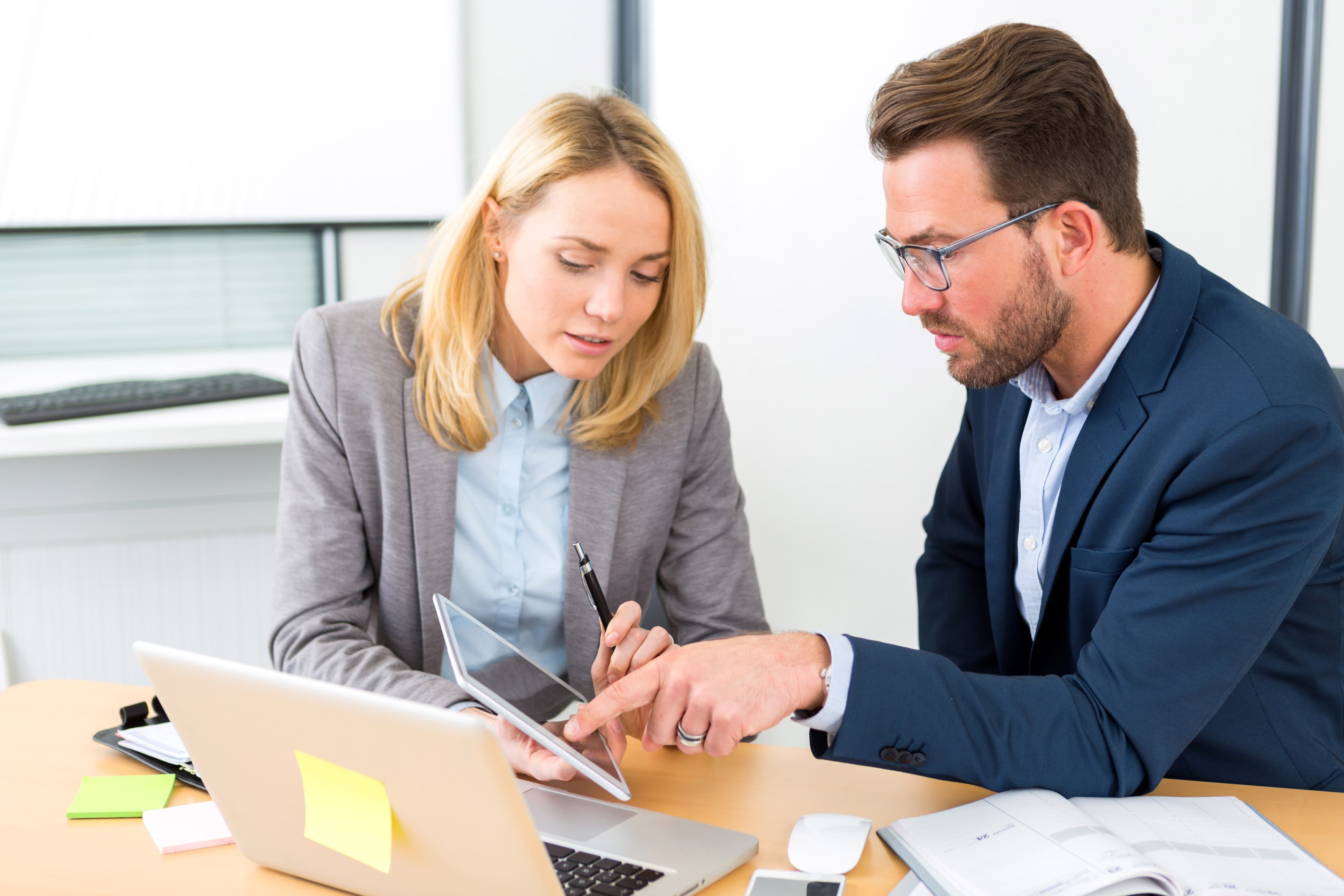 Businessman and his assistant working together at the office